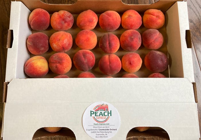 white box of peaches