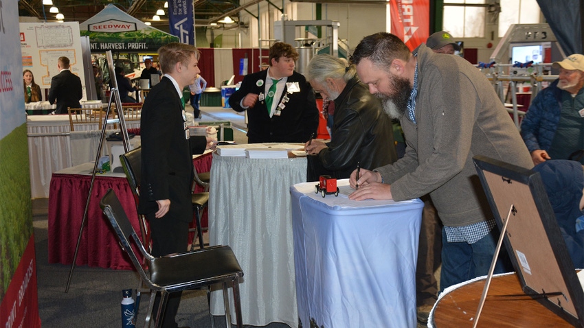 Visitors at a New York Farm show booth