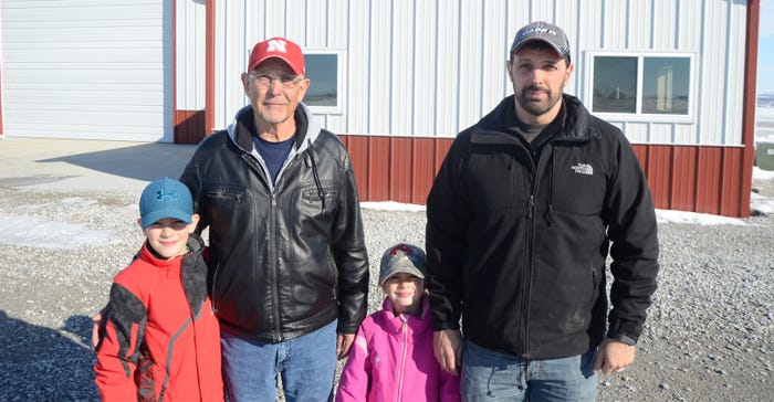 Gary and Randy Reinke, and Randy's son Blake and daughter Annalise stand outside the Reinkes' farm shop in Otoe County