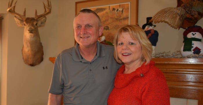 Janet and David olson in living room next to hunting trophies Janet and David olson in living room next to hunting trophies