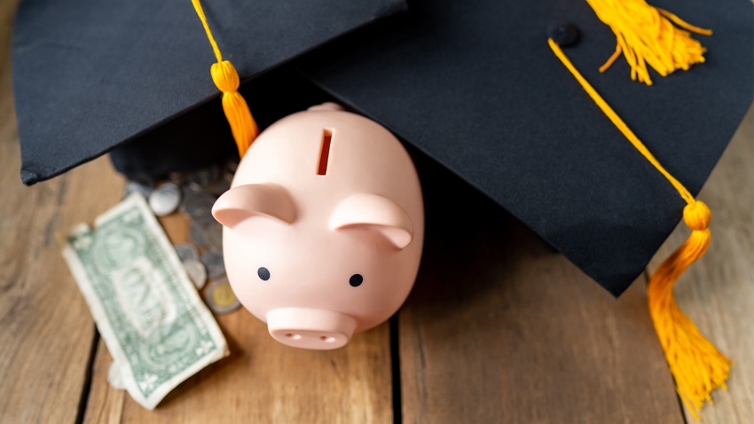 piggy bank with graduation cap and money