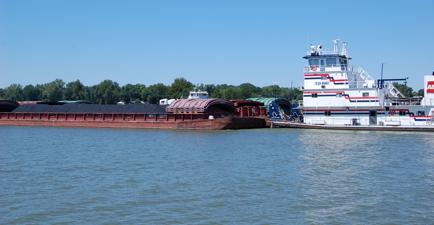 barge carrying cargo down a river