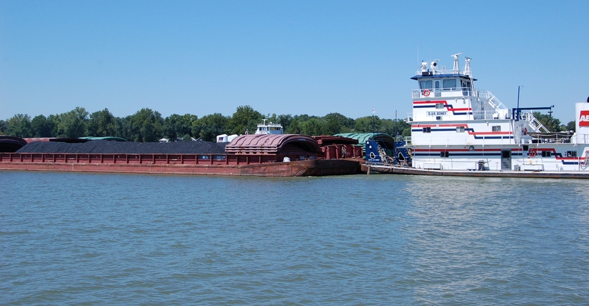 barge carrying cargo down a river barge carrying cargo down a river