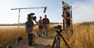 A video production crew films Lisa and Philip Volk on their farm 