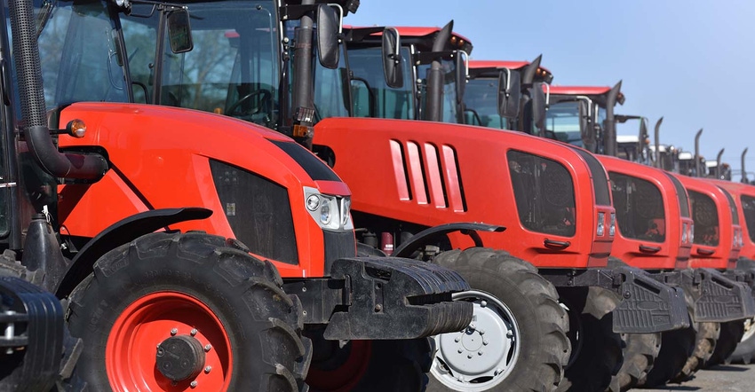 Red tractors parked in a row