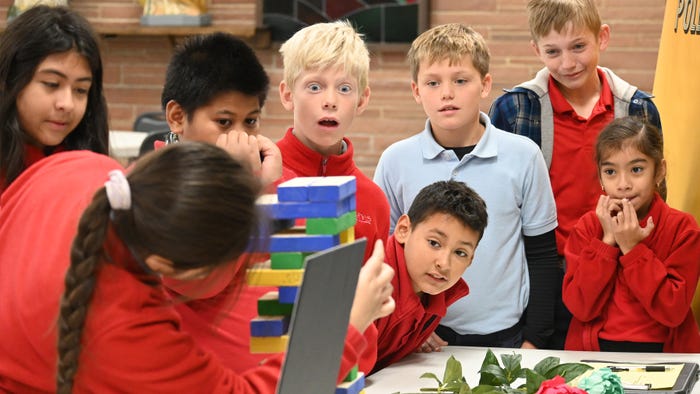 Grade school kids crowded around Jenga game Grade school kids crowded around Jenga game