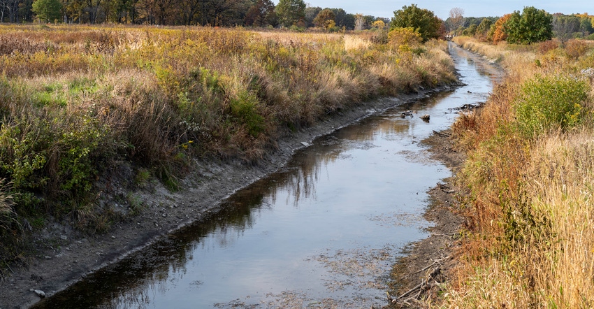 stream of water running along a field during fall stream of water running along a field during fall