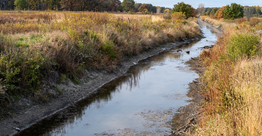 stream of water running along a field during fall