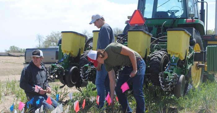 Northeast Community College students looking for planting anomalies to help identify problems with the planter 