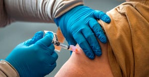 individual receiving COVID19 vaccine in arm