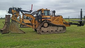 machinery sits in field waiting to dig for tile installation