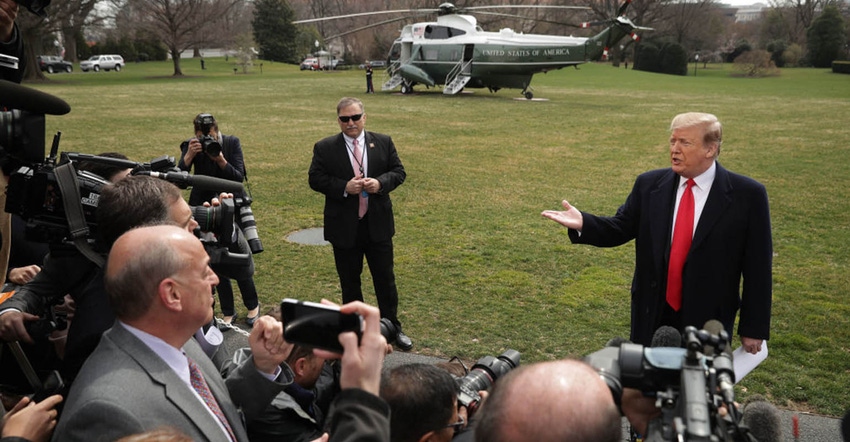 U.S. President Donald Trump talks with journalists before departing the White House March 20, 2019, in Washington, DC. Trump 