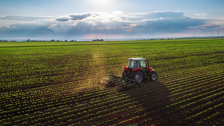 A tractor cultivating a field