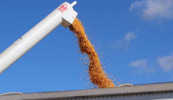 corn bein loaded into grain cart