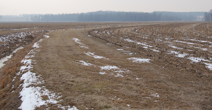 ditch at edge of winter farm field with a filter strip in between