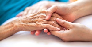 woman holding elderly ladies hands