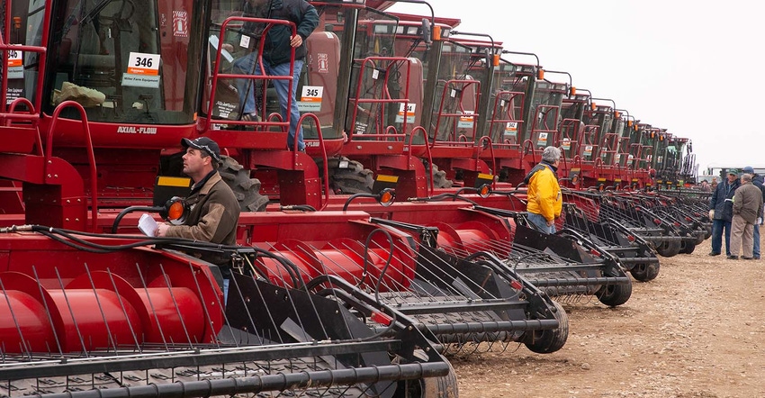 Customers inspect combines prior to an auction in Saskatoon, SK