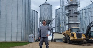 Dusty Cupp of Menton, Mich., standing in front of his grain drying and storing system