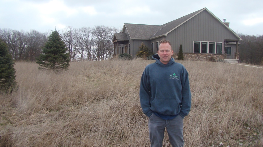 Brad Hunter stands in the native grasses at the edge of his yard