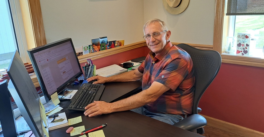 John Ruedinger sitting at his desk in his office John Ruedinger sitting at his desk in his office