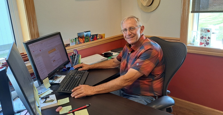 John Ruedinger sitting at his desk in his office