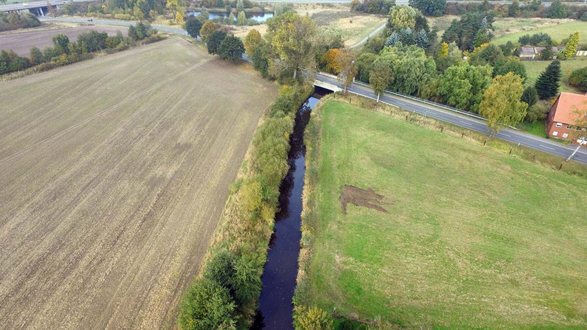 Ditch with water through a field