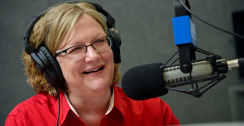 RFD Radio’s Rita Frazer with headphones on in front of microphone
