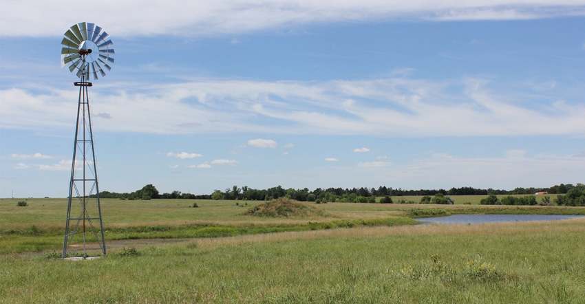 farmland with windmill in foreground