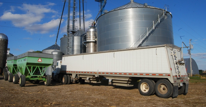 grain truck filling up near silo