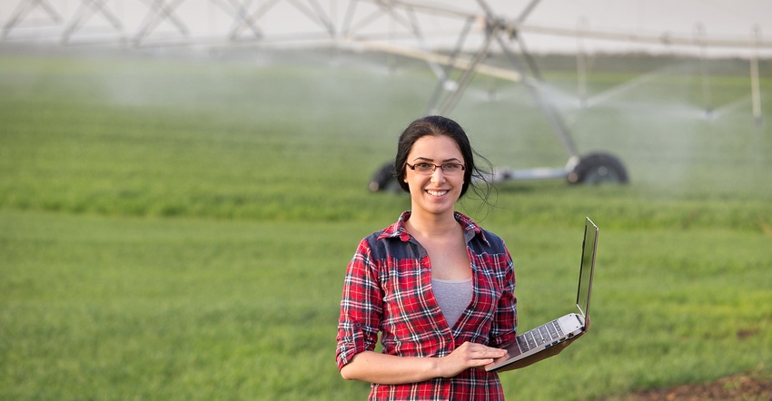 farm woman with laptop and irrigation