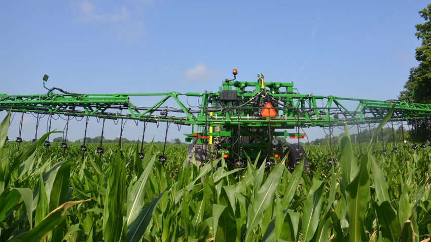 sprayer in cornfield