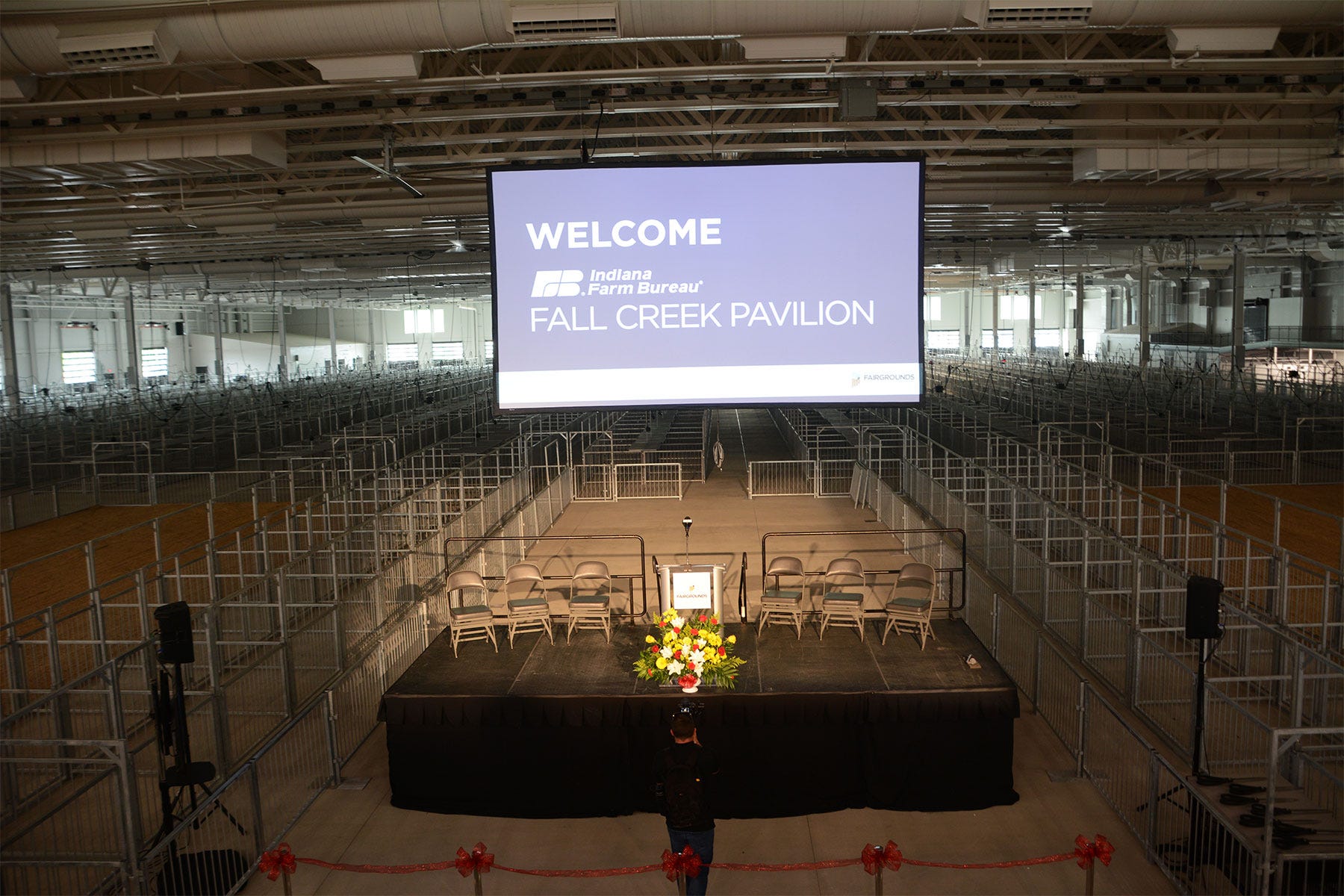 stage surrounded by hog pens inside Farm Bureau Fall Creek Pavilion 