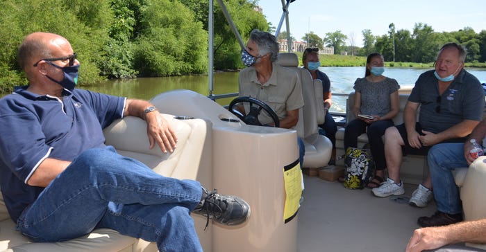 Dan Wire pilots a boat on the rivers through downtown Fort Wayne, Ind., carrying guests from the Natural Resources Conservati