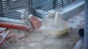 Close-up of an unloading auger moving grain from a bin