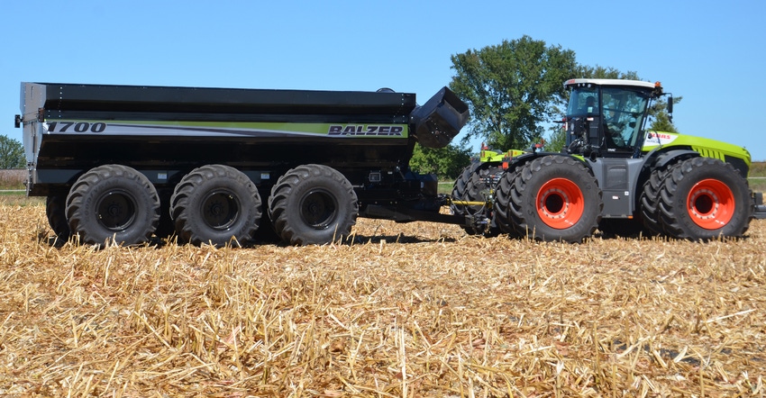 tractor and grain cart in no-till cornfield