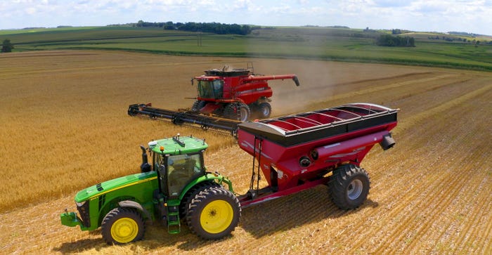 Combine harvests wheat using OMNiDRIVE aftermarket autonomous cart system