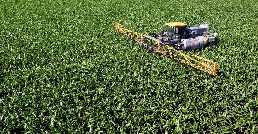 Sprayer applying nitrogen fertilizer to field