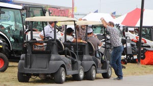attendees riding in golf cart around HHD