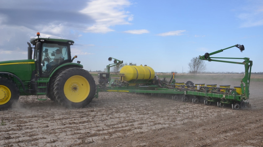 tractor and planter planting corn