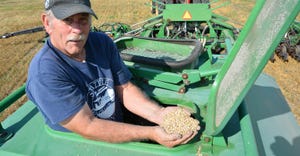 Curtis Knutson checks the cover crop seed he is planting