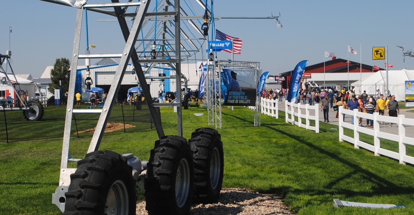 Visitors at HHD walking the streets as vendor shows off irrigation equipment