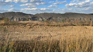 A mining landscape in Boonville, Ind., against a blue sky with clouds