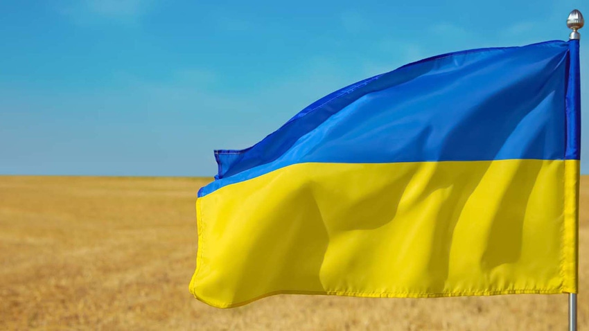 Ukraine flag with wheat field in background