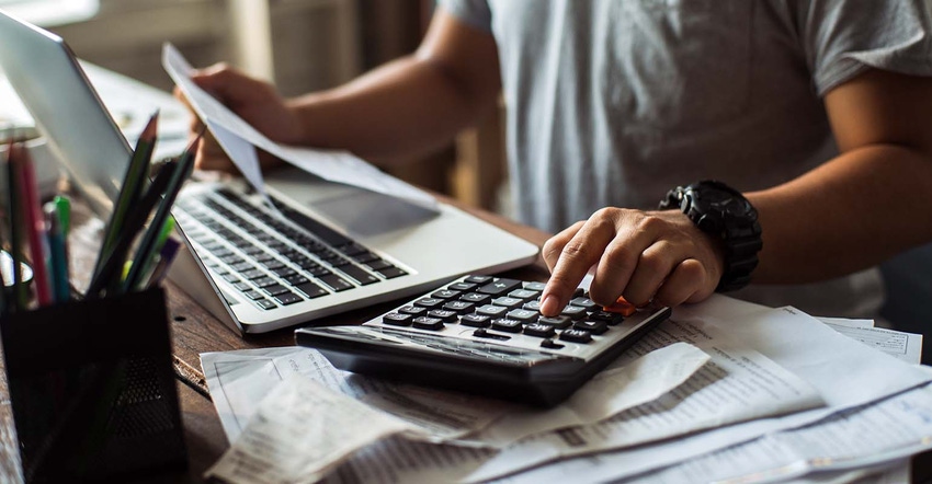 person on laptop with calculator