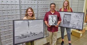 3 employees of U-MN Crookston hold framed images, part of 80+ photo exhibit: Roots of the Red River Valley