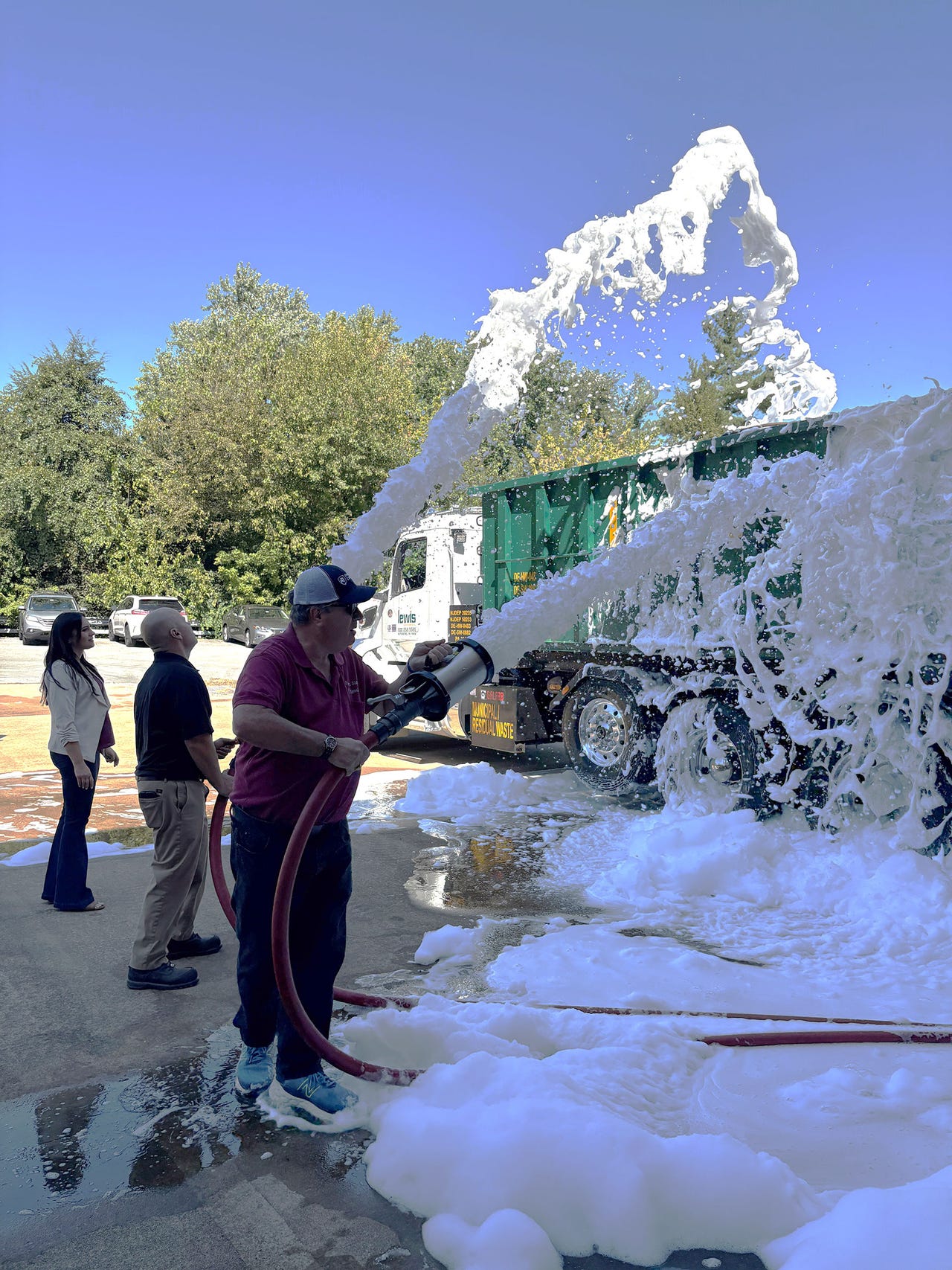 Men spray truck with foam