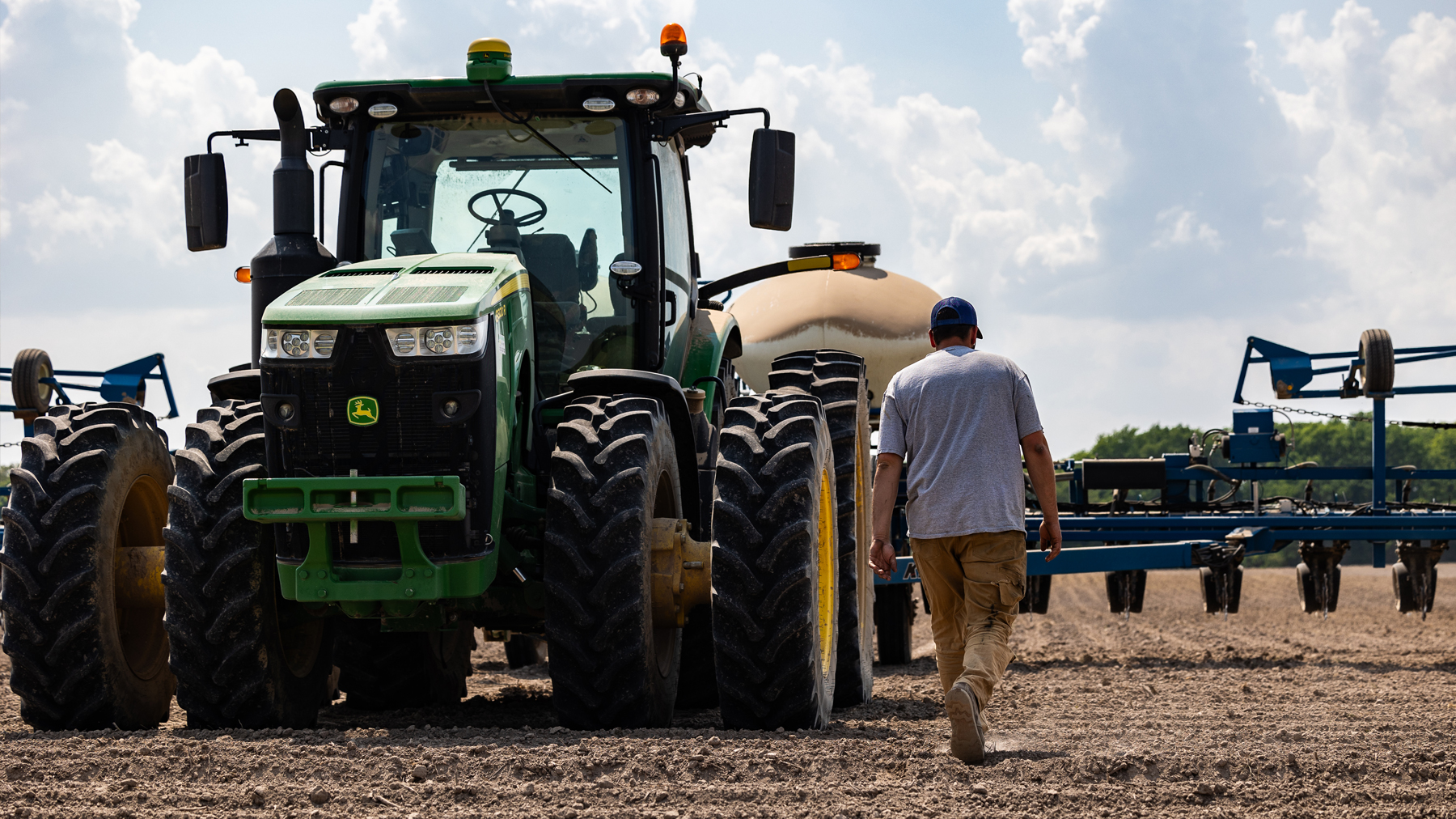 farmer and equipment in field 