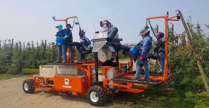 Pickers atop a DBR Bandit Cyclone make a full turn and head into another row of the apple orchard