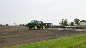 A tractor spraying a field