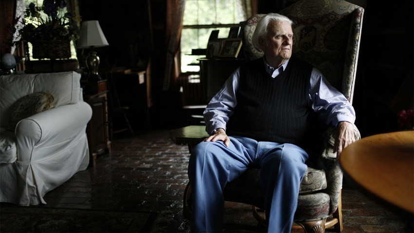  Billy Graham sitting in a chair at his home
